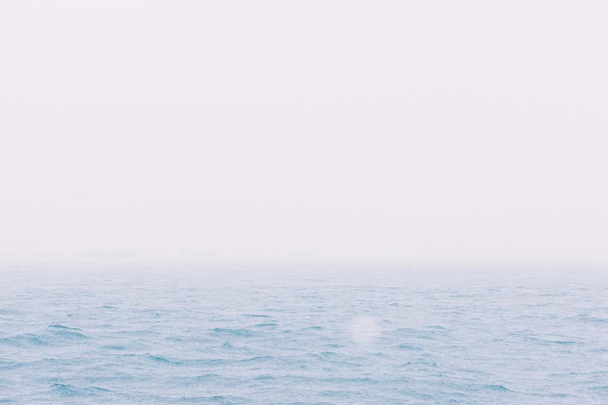 blue body of water during daytime photo sky