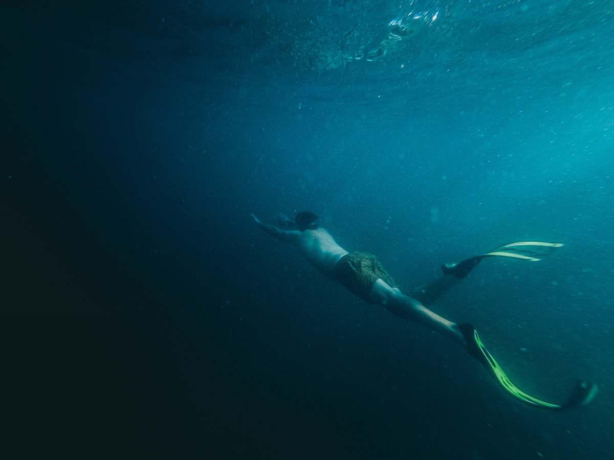 diving person swimming underwater diver