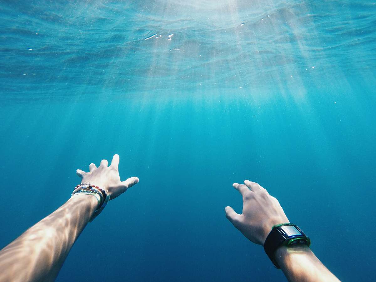 sea person wearing rectangular black watch blue