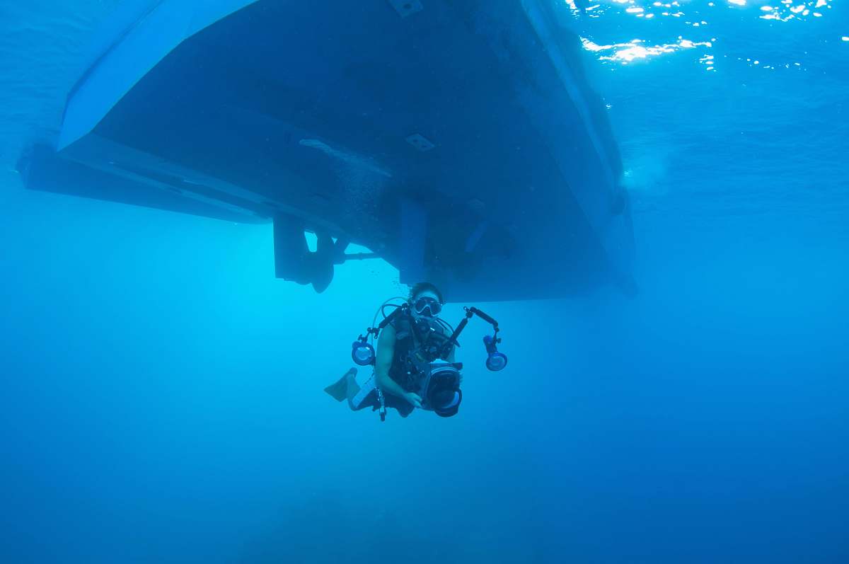 human underwater photography of person holding camera outdoors