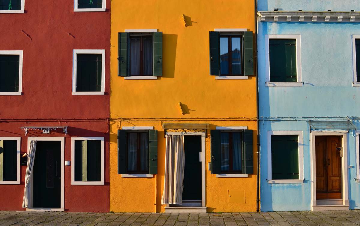 yellow minimalist photography of open doors and windows of colored buildings facade