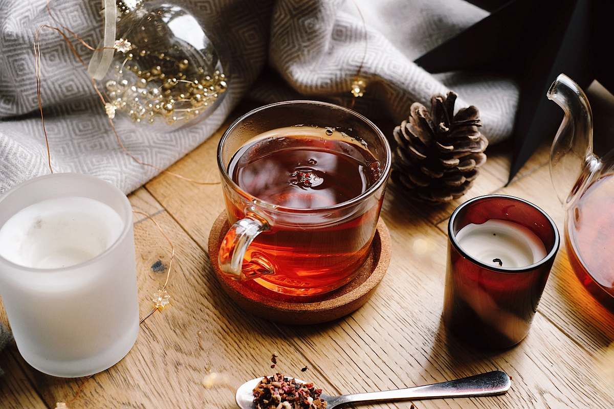 milk tea cup beside brown pine cone beverage