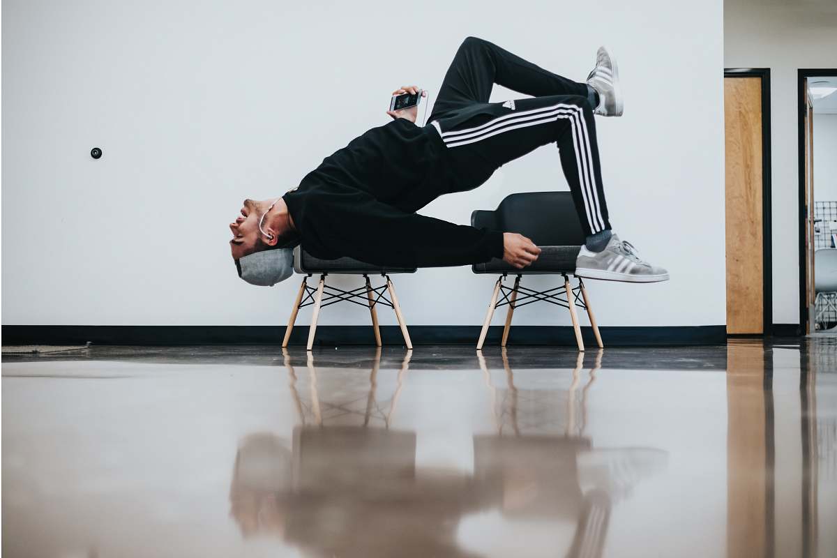 person man sitting on chair near wall los angeles