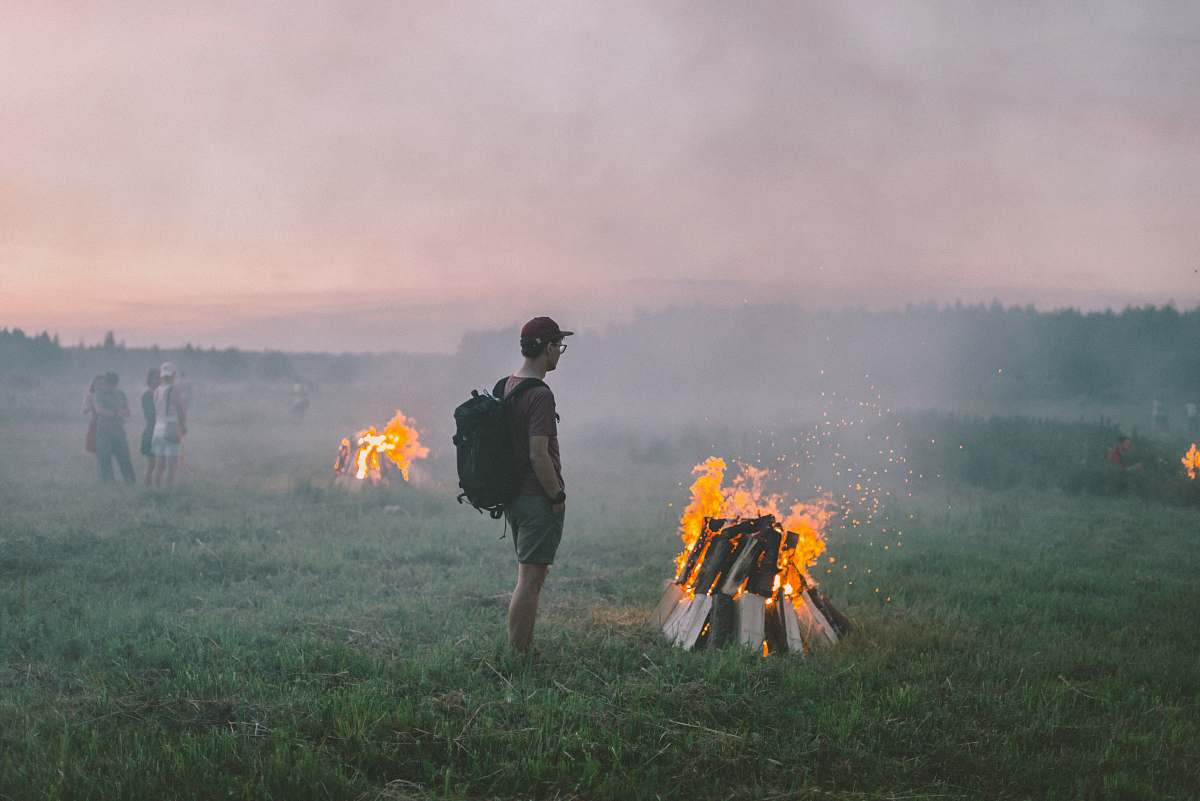person man standing near flame fire
