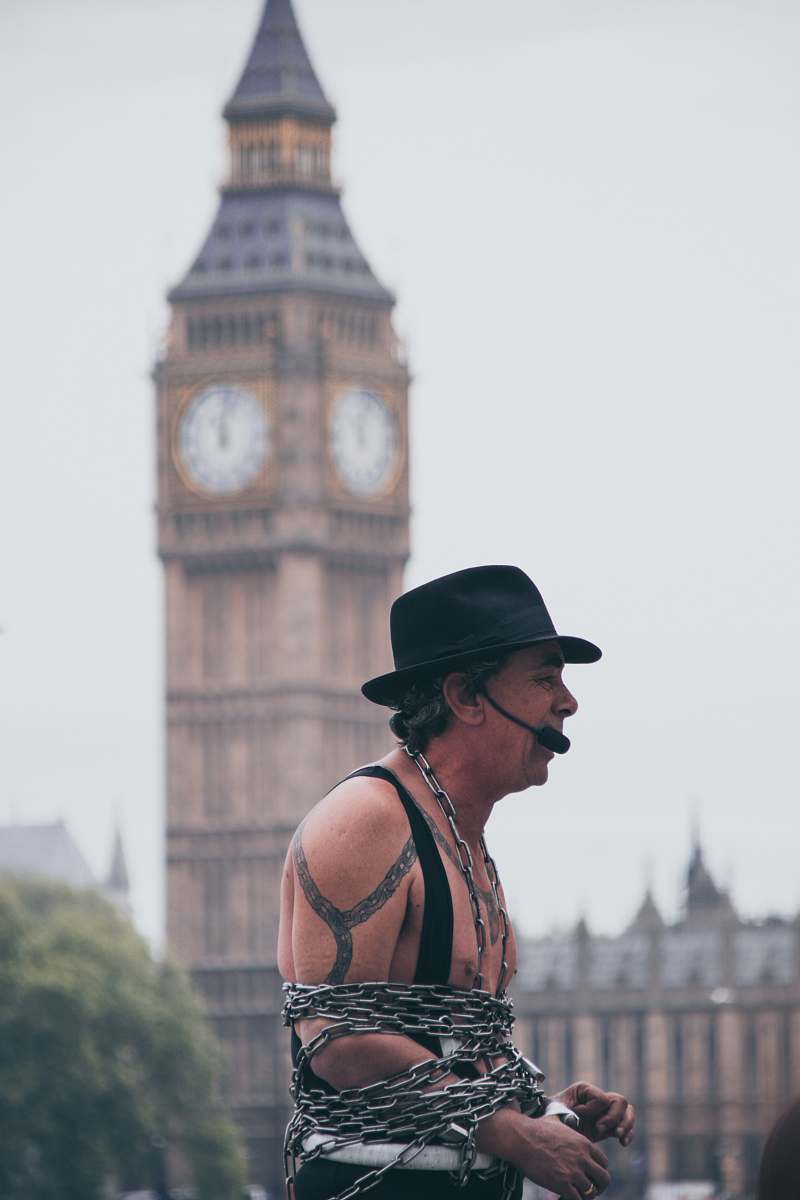 person selective focus photo of man covered with chain with microphone with a view of big ben people