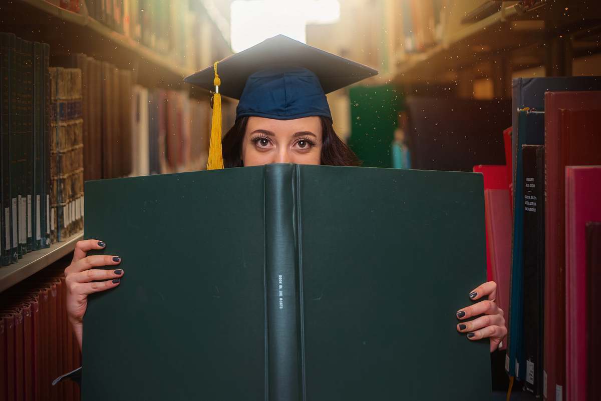 person woman holding book graduation
