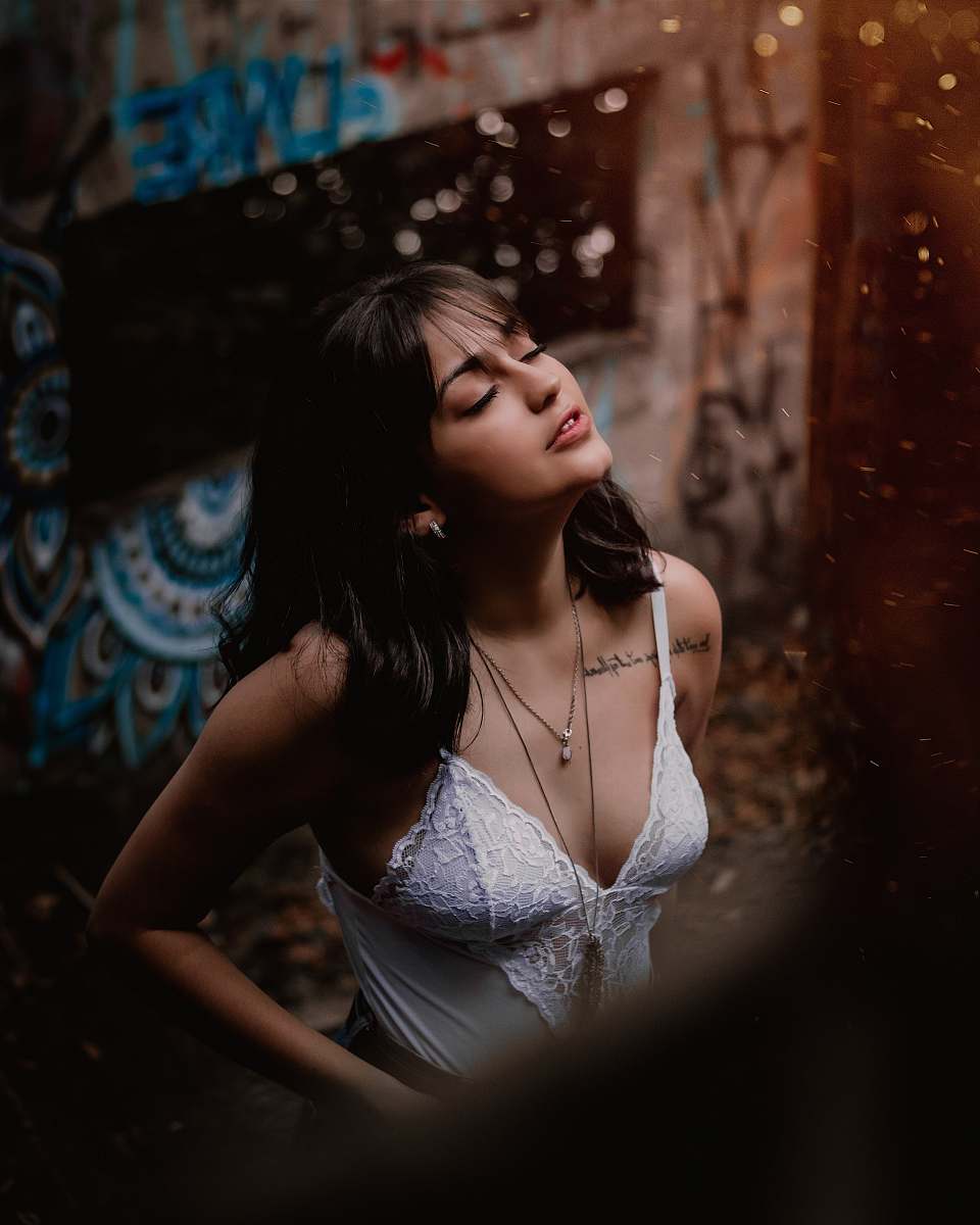 clothing woman in white tank top standing near building person