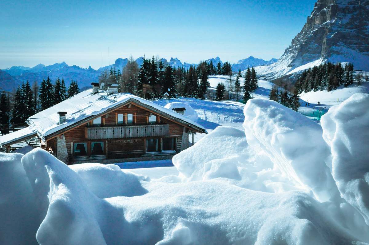 civetta brown house beside mountain with snow tree