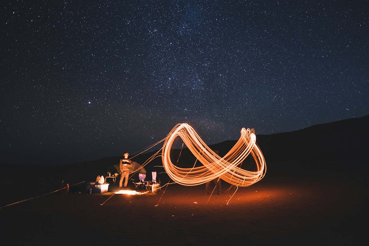 stars timelapse photography of steel wool fire dancing at night oman