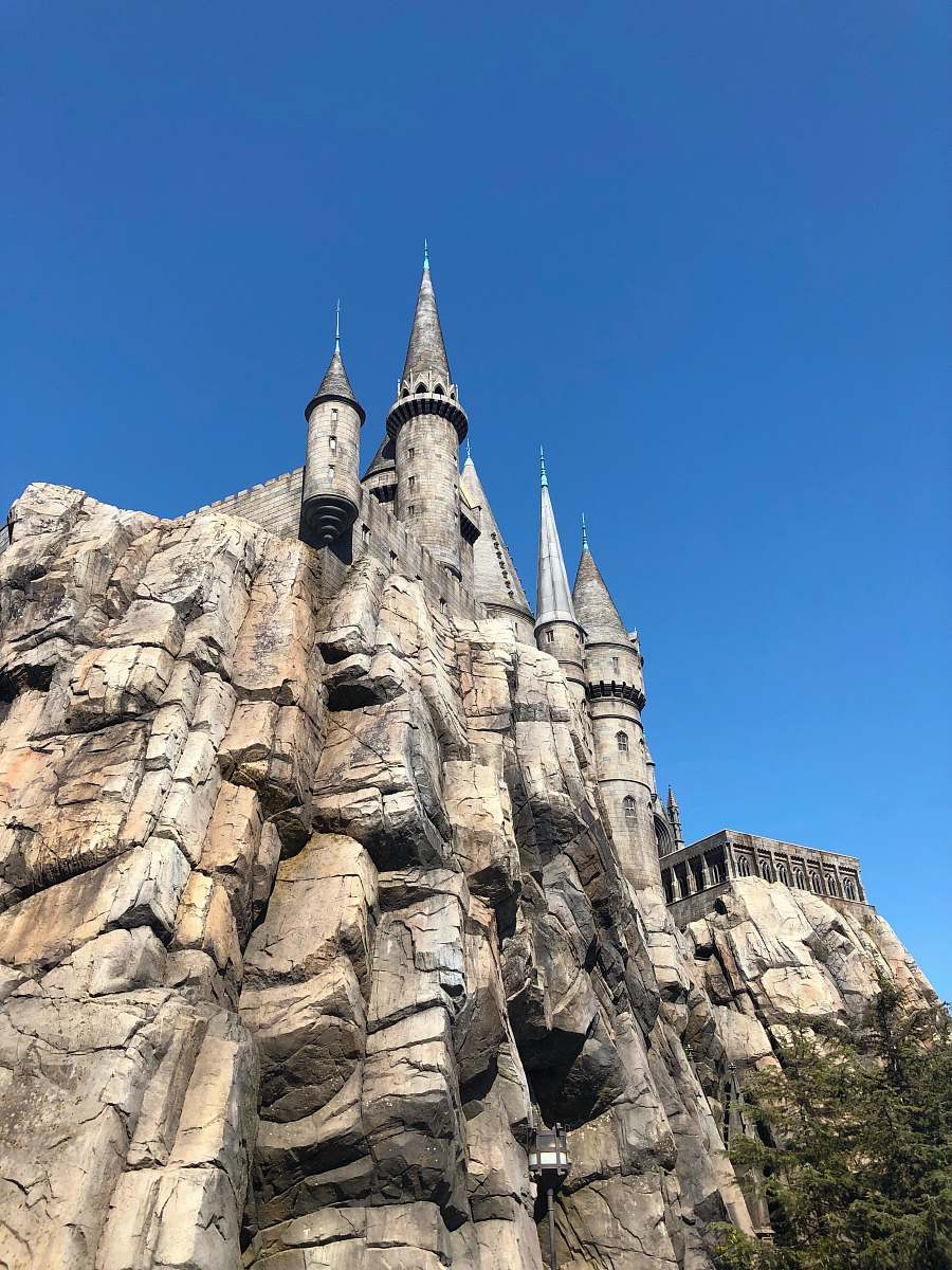 housing gray concrete castle on cliff during daytime spire