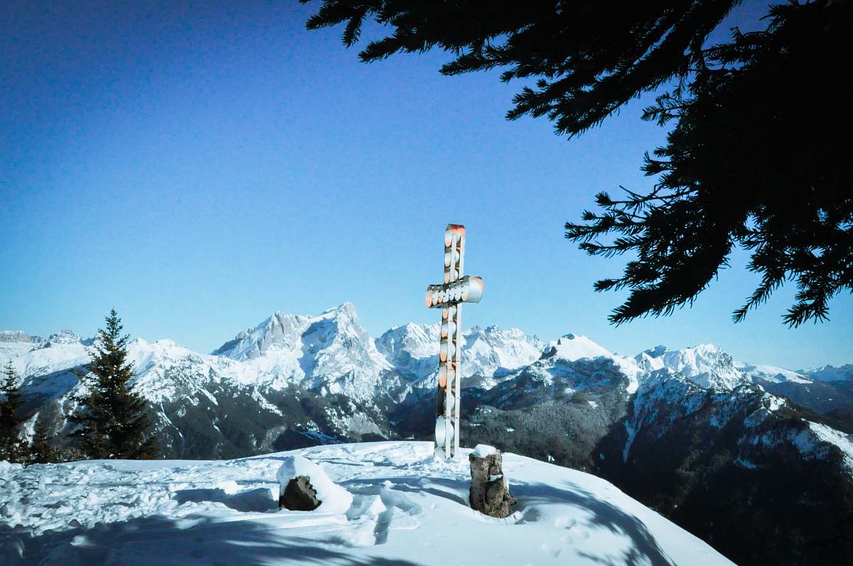 snow selective focus photography of cross italy