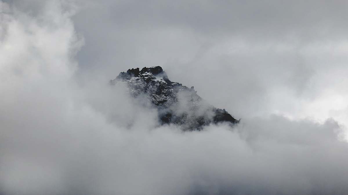 clouds Snowy mountain summer peeks through clouds in Franz Josef Glacier outdoors