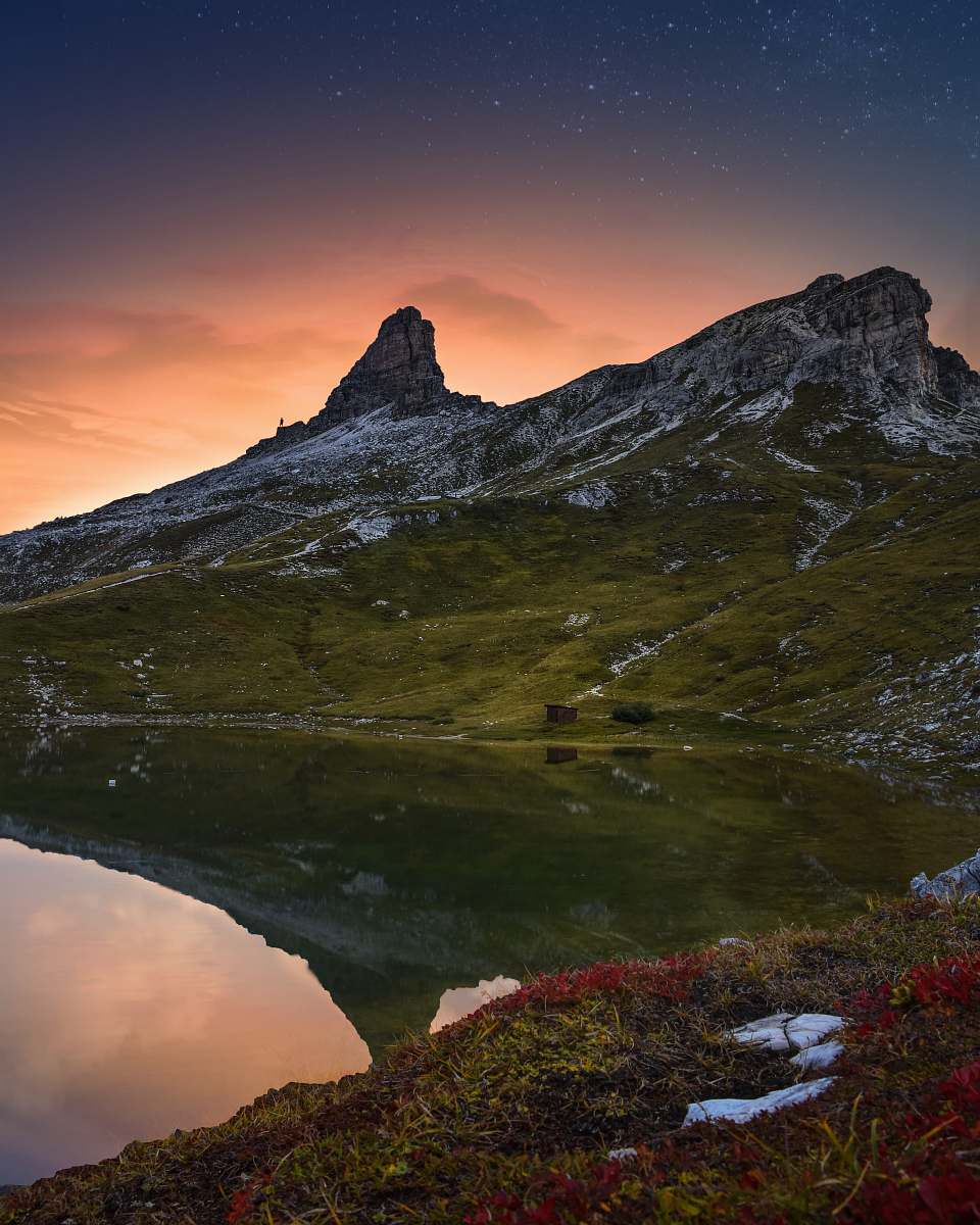 mountain lake surrounded by rock formation mountain range