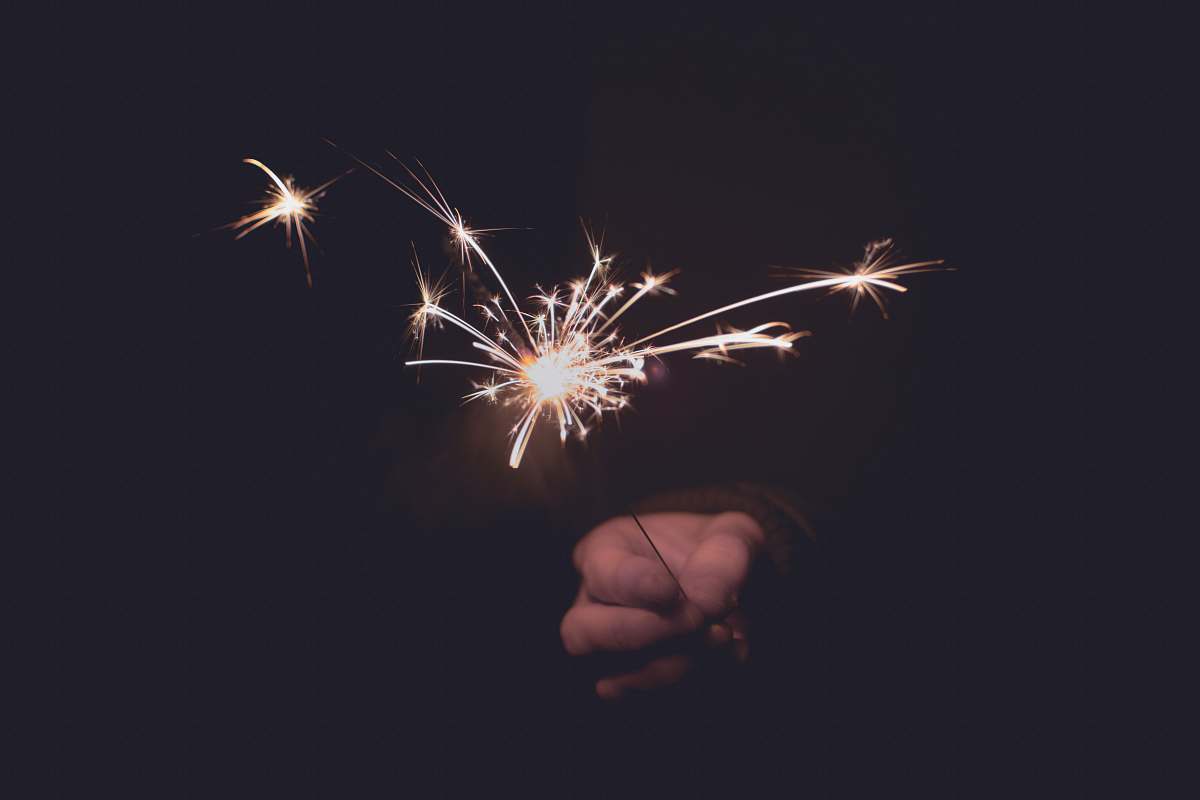 night person holding sprinkler firecracker fireworks