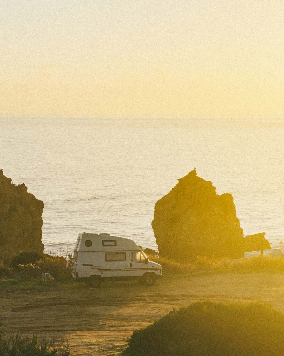 nature white motorhome near cliff during daytime van