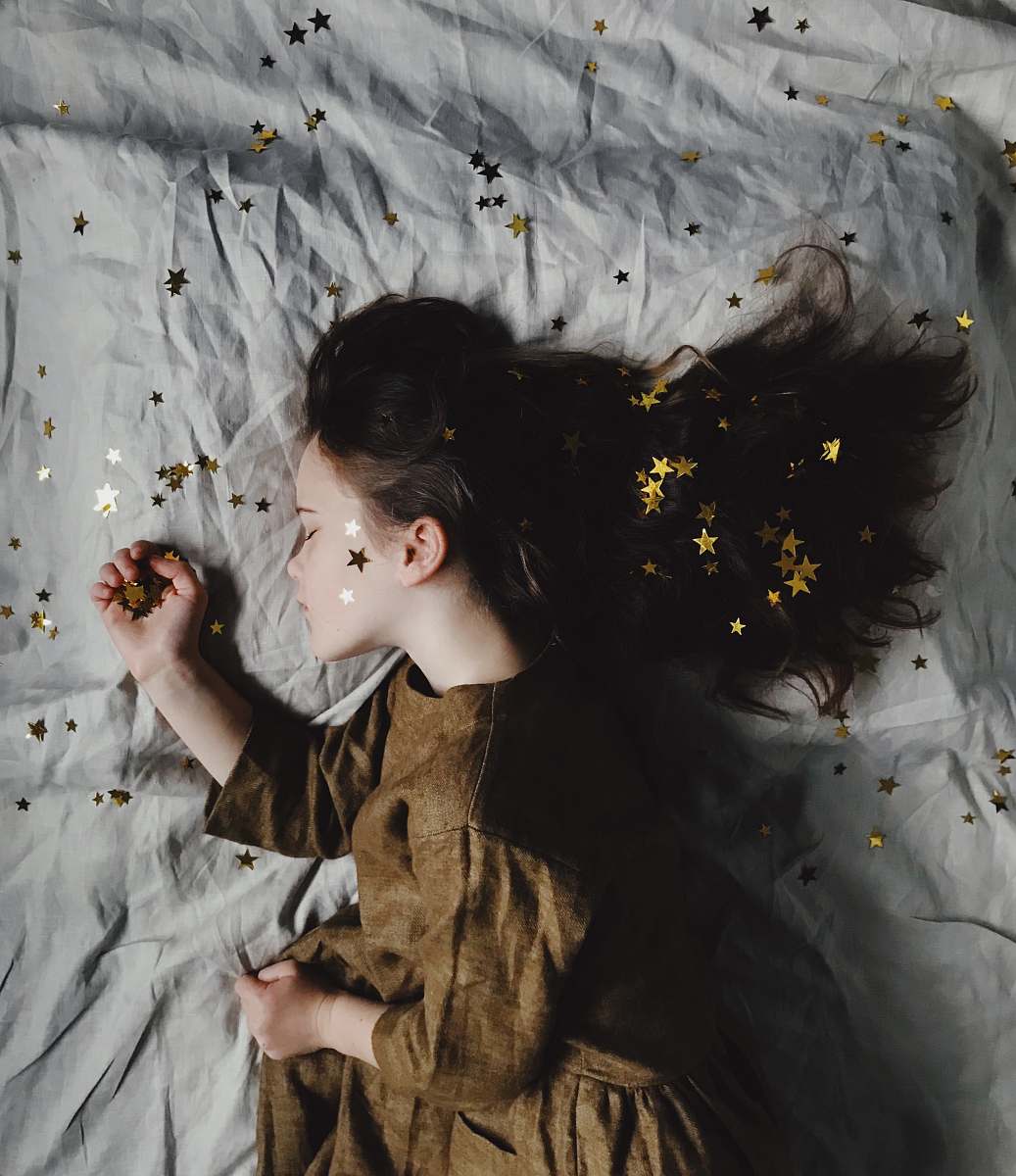 person woman in brown long-sleeved top sleeping on bed human