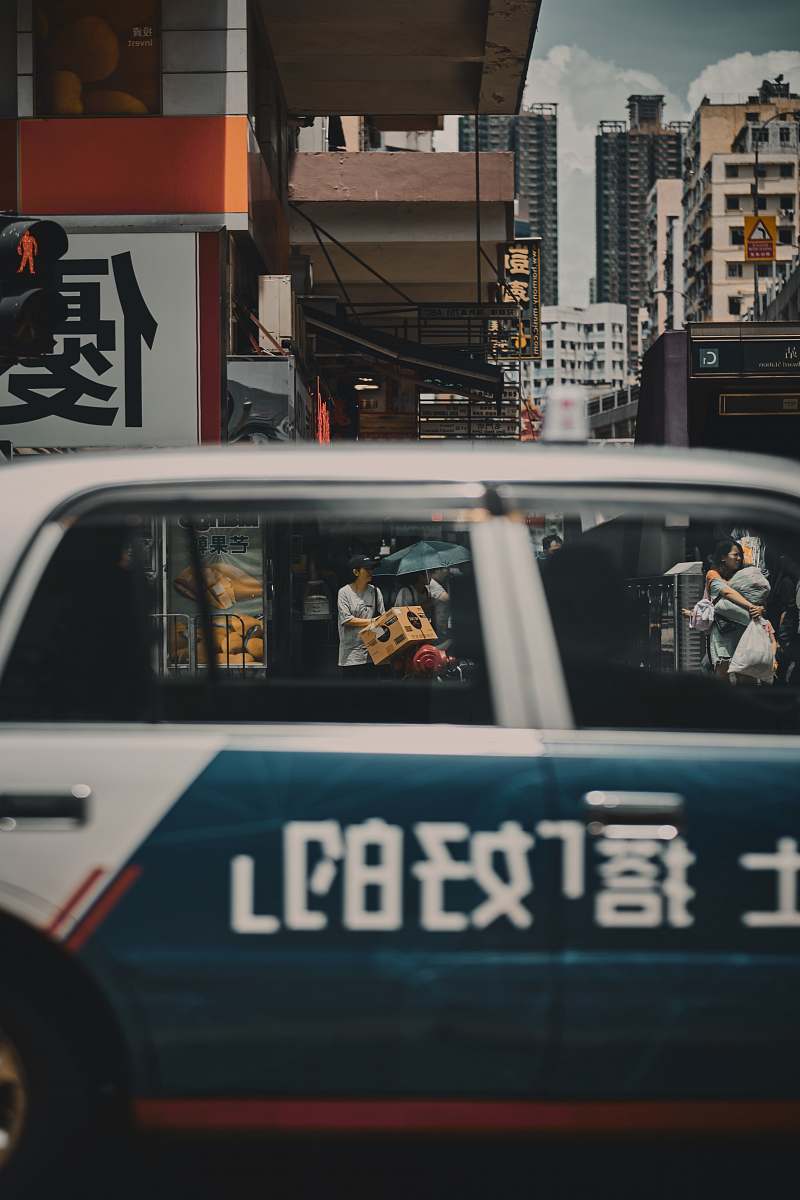 human car near people and buildings during day car