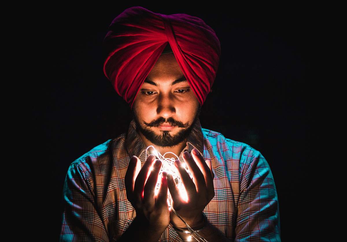 human man holding string lights people