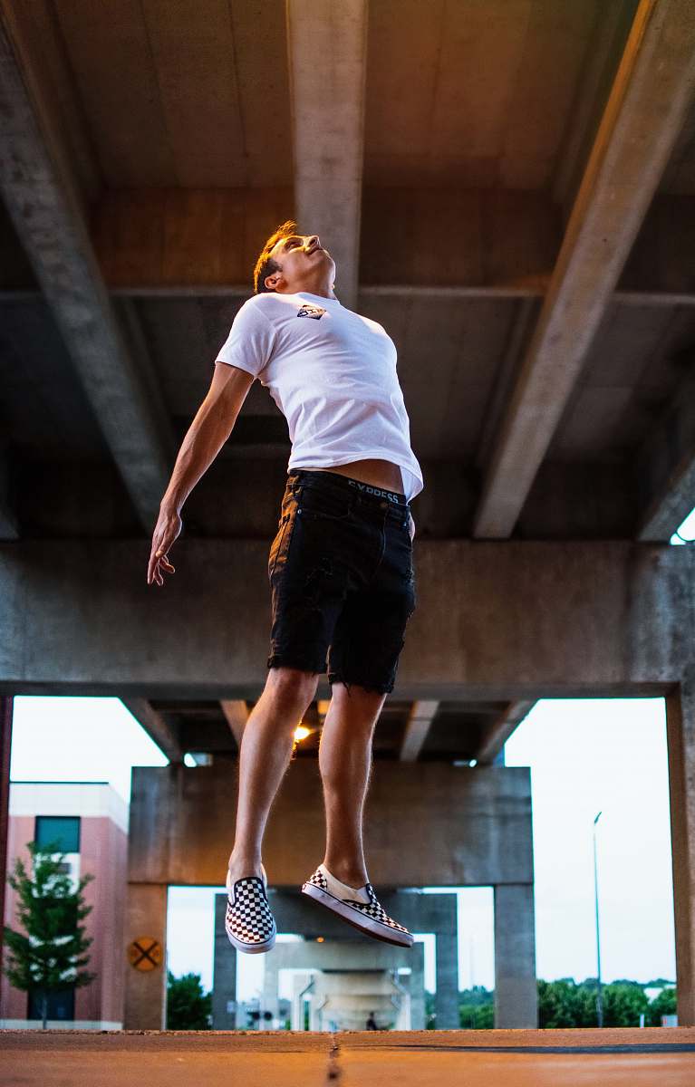 human man jumping during daytime people