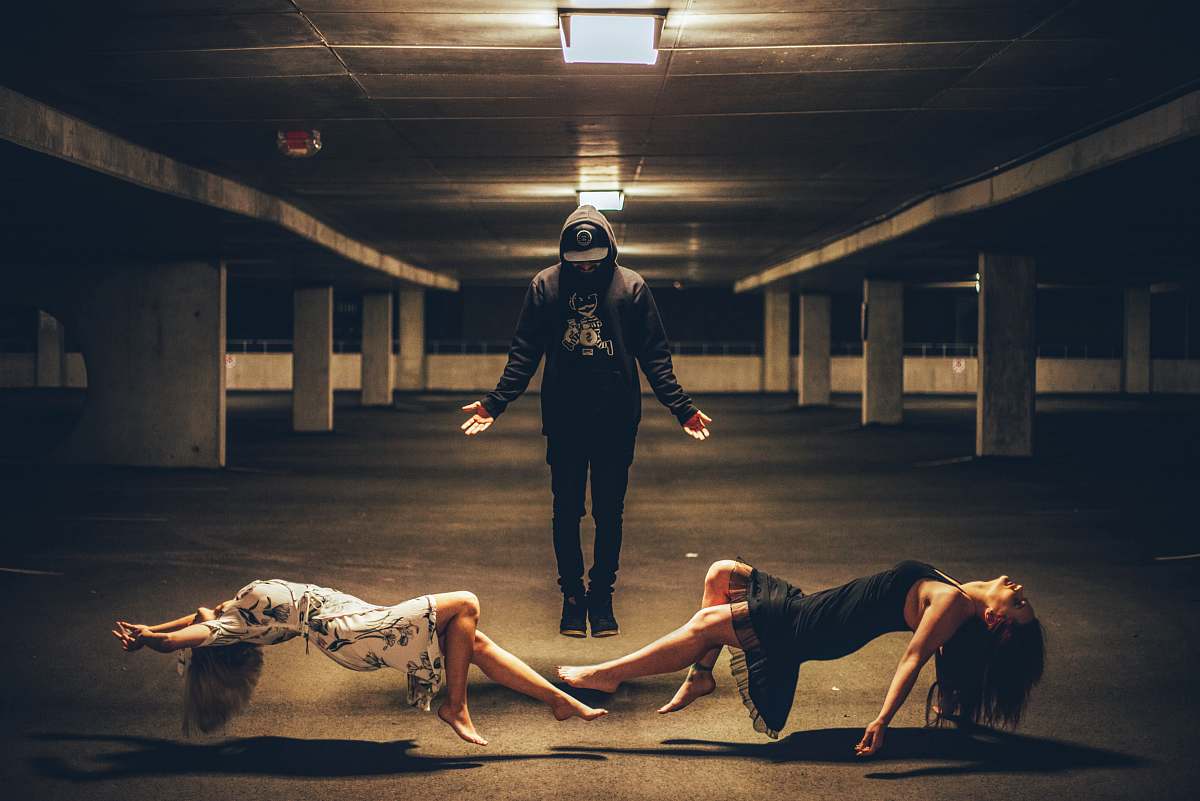 people man standing between two women lying human