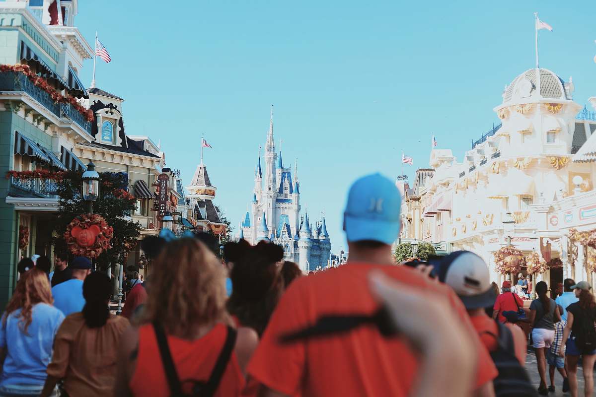 human people walking near concrete buildings during daytime theme park