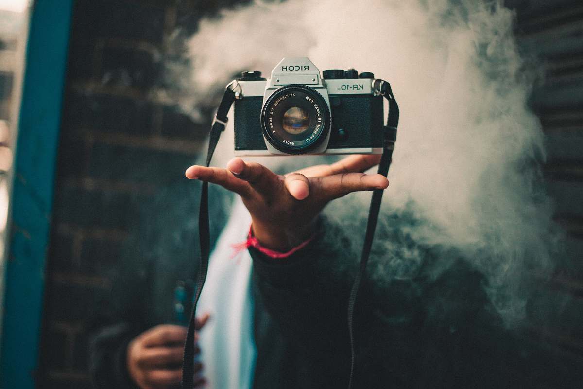 human person catching Ricoh DSLR camera people
