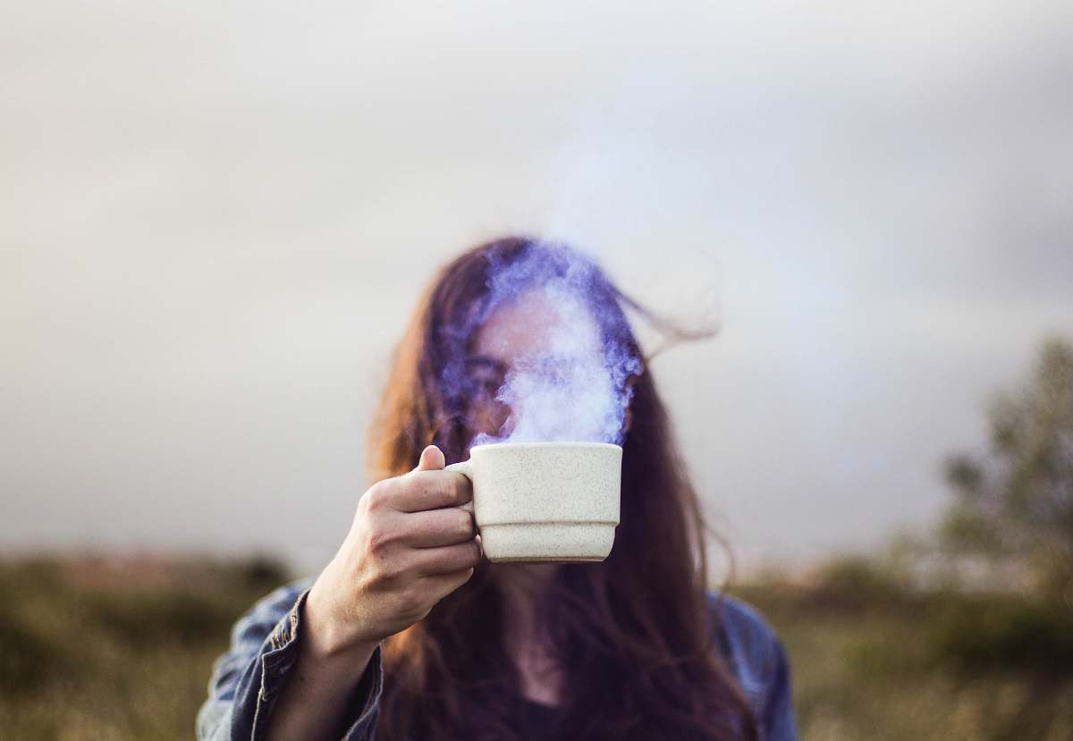 human selective focus photo of man holding white ceramic coffee cup people