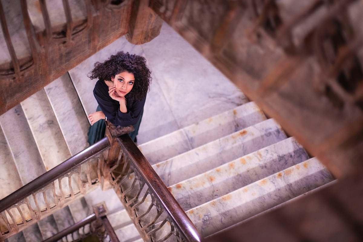 handrail shallow focus photo of woman standing on stairs banister