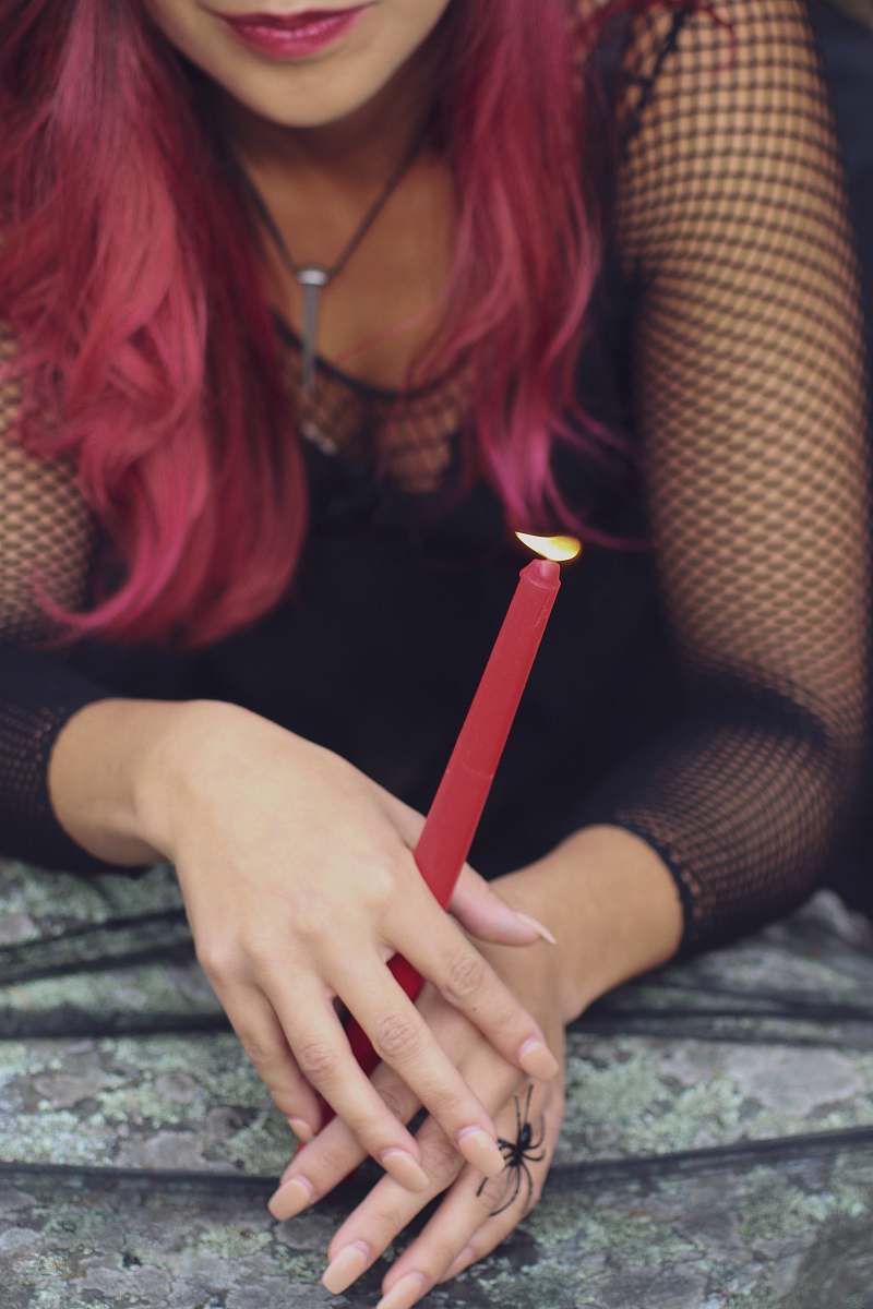 human woman wearing black long-sleeved top candle