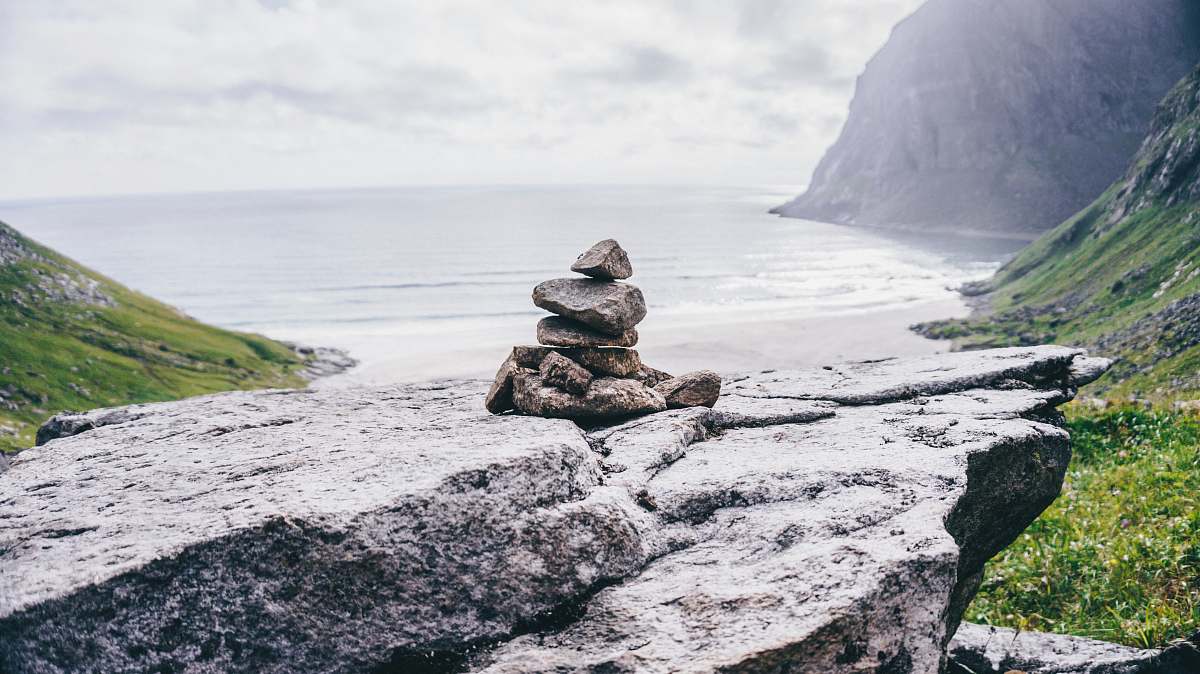 grey cairn stones on rock formation norway