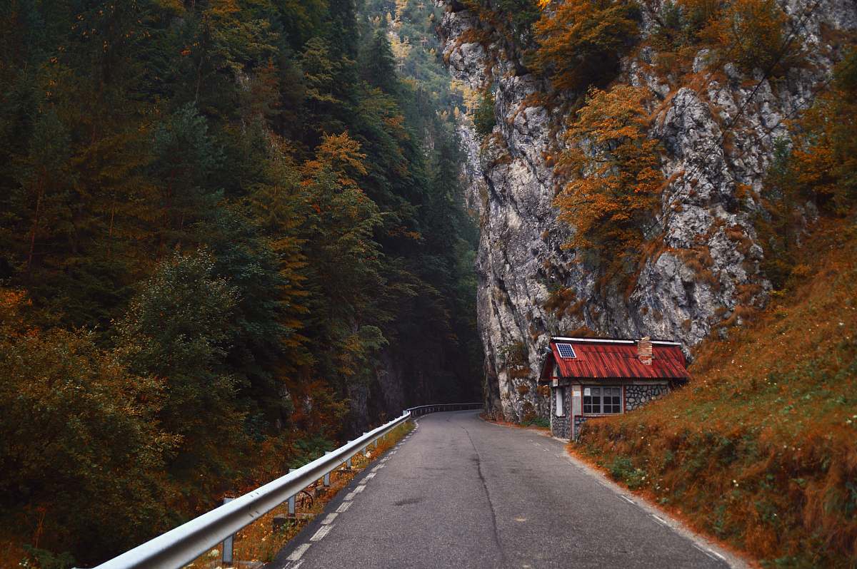 road gray asphalt road in between rock mountains cliff