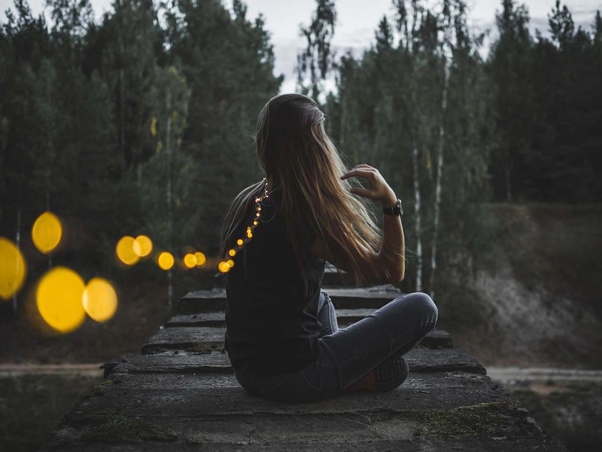 person woman sitting on concrete edge female