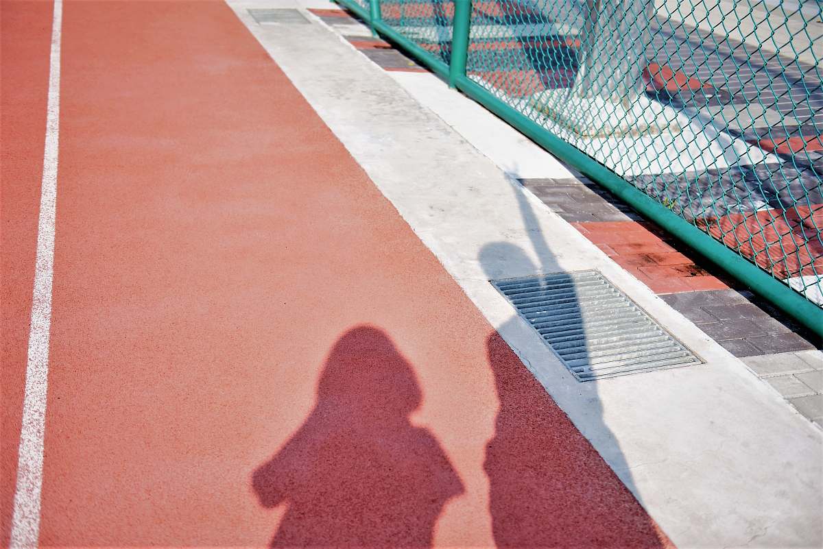 premiere two person's shadow on brown and red surface red carpet