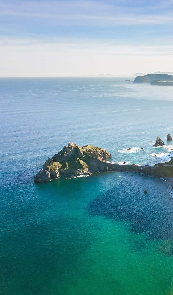 coast aerial photography of islet ocean