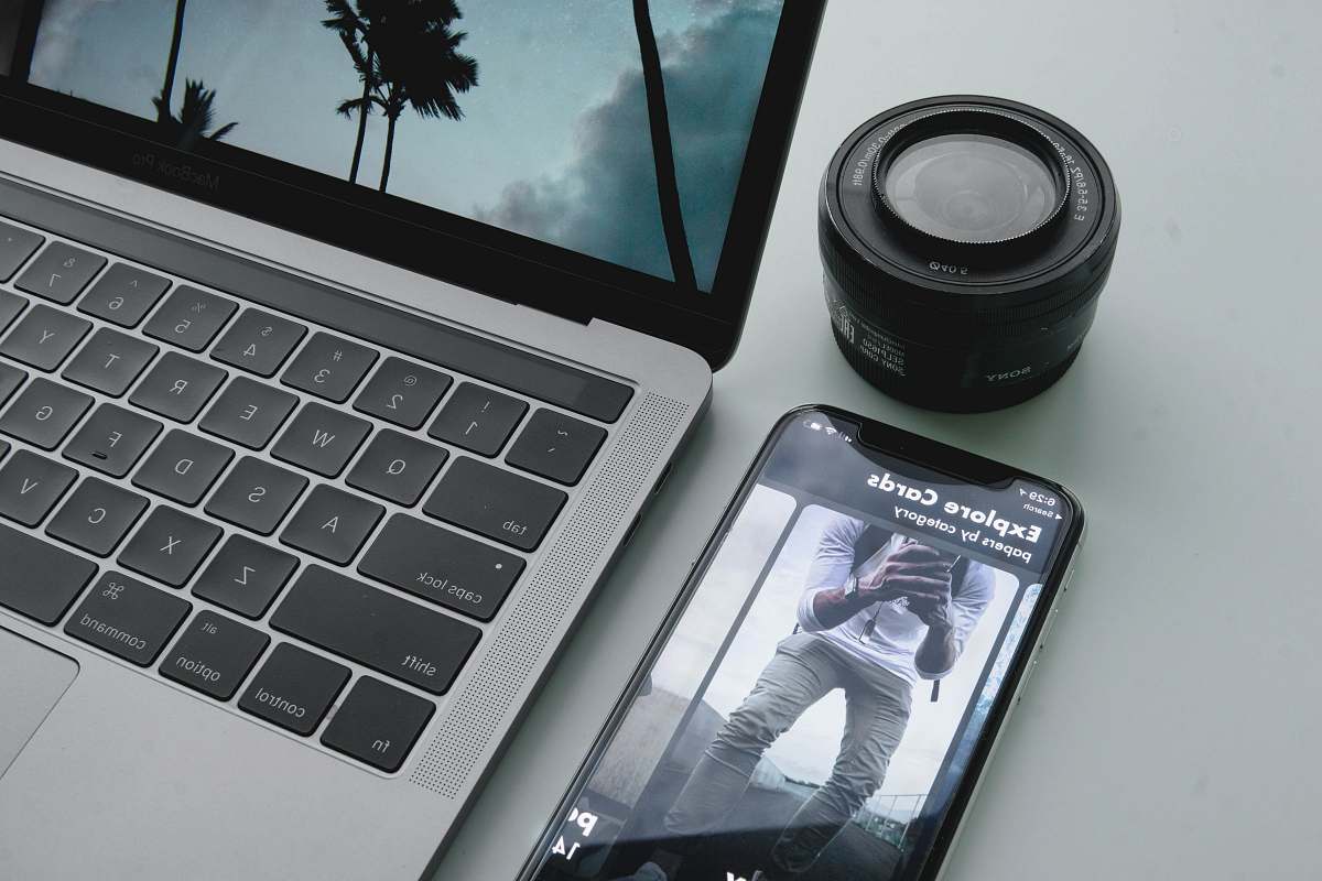 flora black phone beside MacBook Pro palm tree