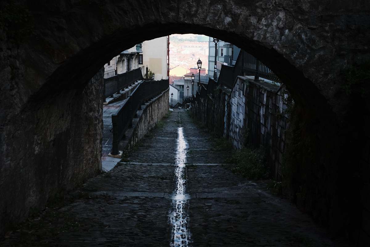 sidewalk empty walkway under arch pavement