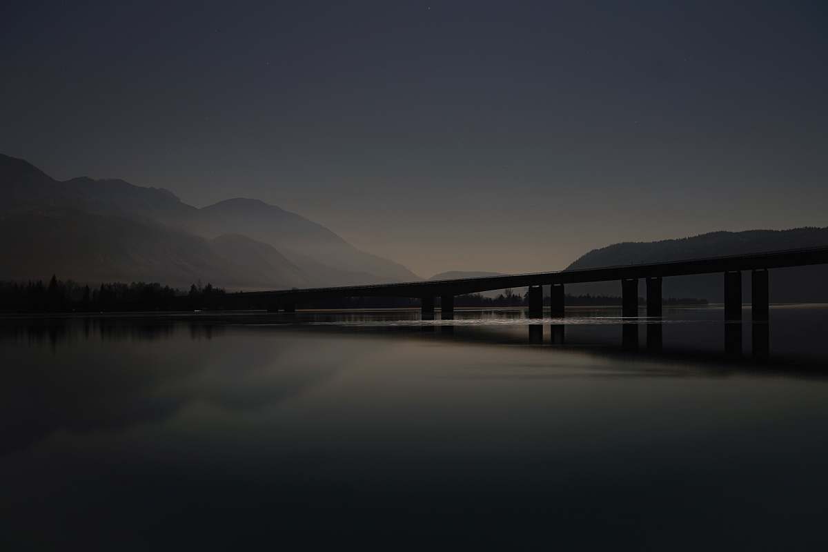 grey calm body of water and dock waterfront