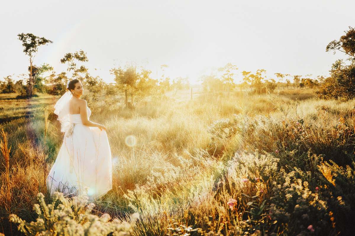 bride woman in white gown on grassland grass