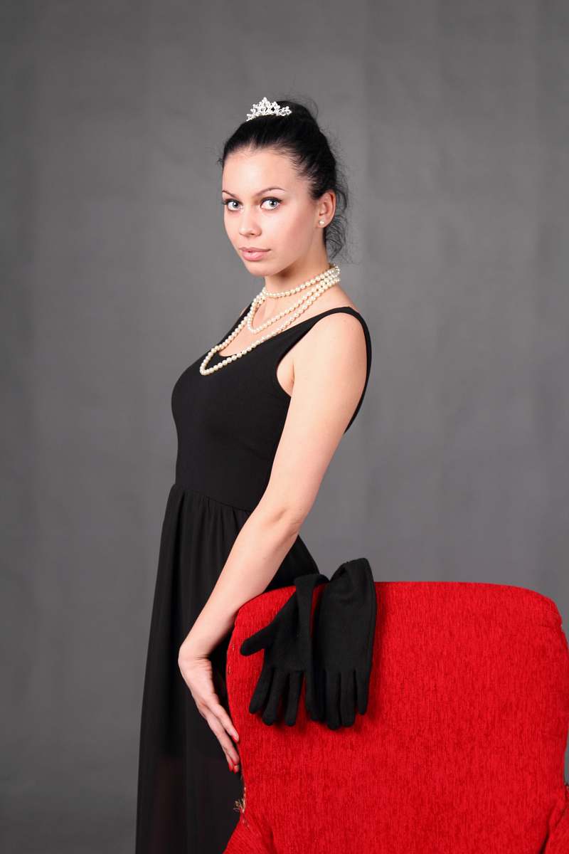 clothing woman standing beside chair fashion