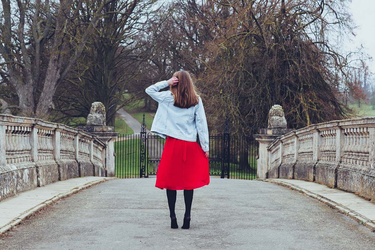 clothing woman standing on bridge during daytime skirt