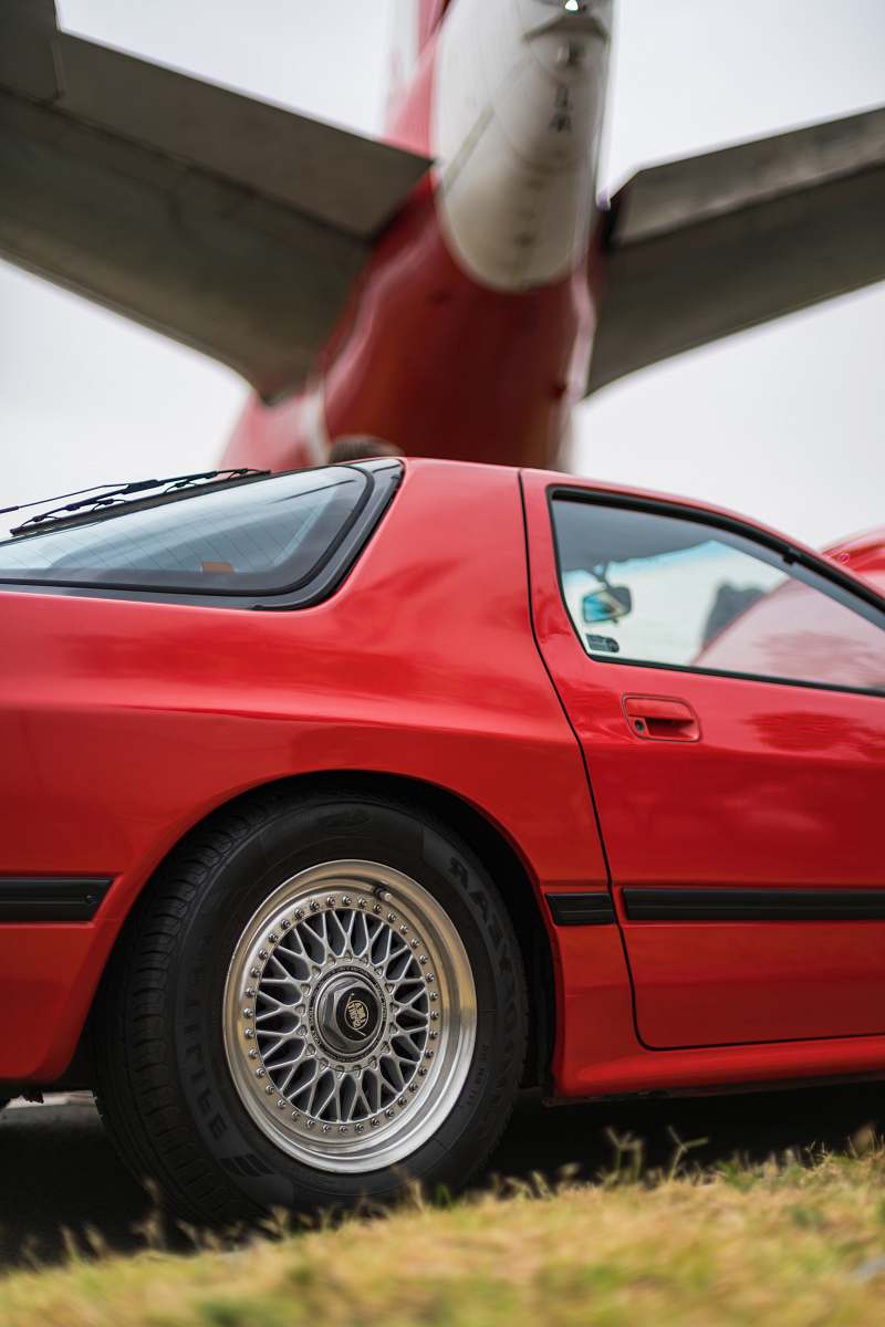 car red coupe under an airplane transportation