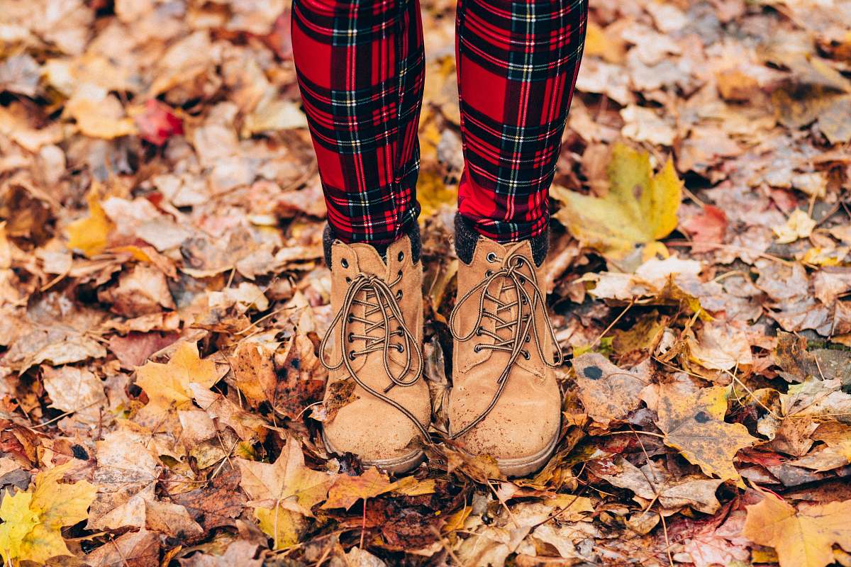 fall person standing on withered leaves plaid