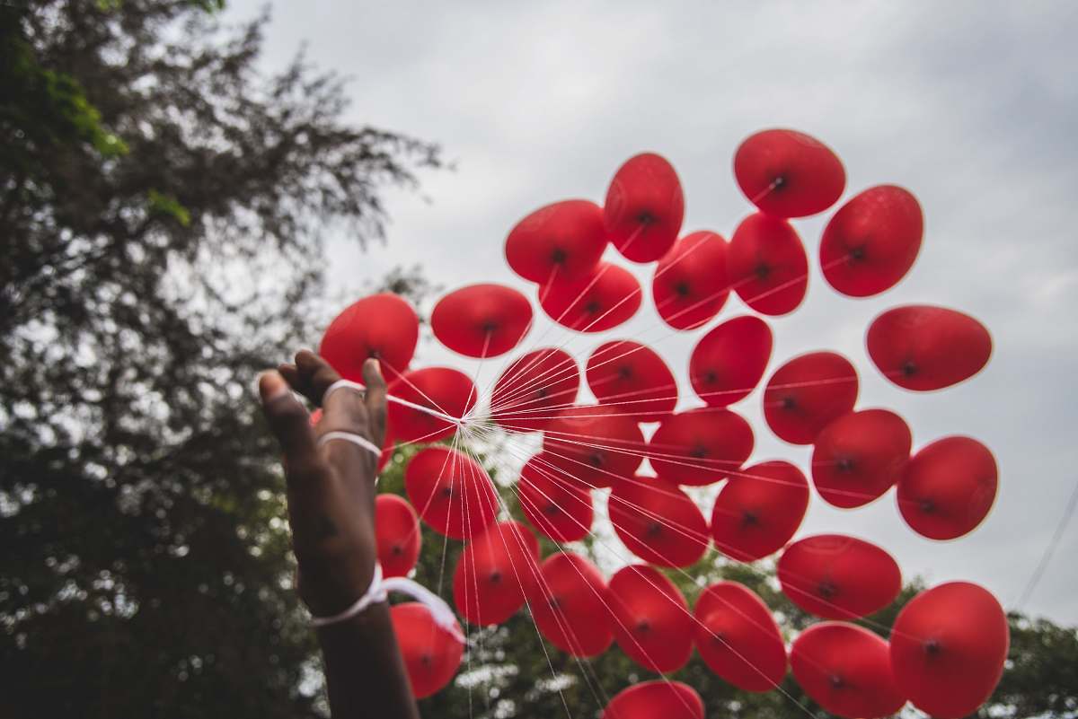 sphere person hand holding red balloons balloon
