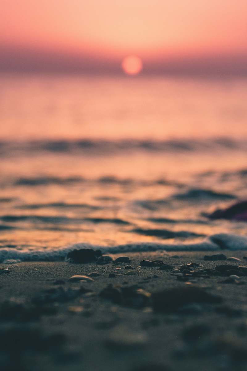 water foreground photography of sand near shore ocean