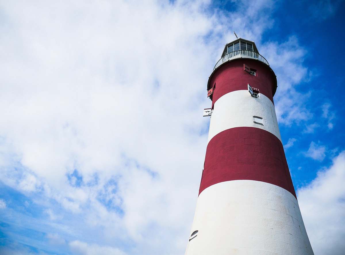 lighthouse red and white lighthouse under cloudy blue sky tower
