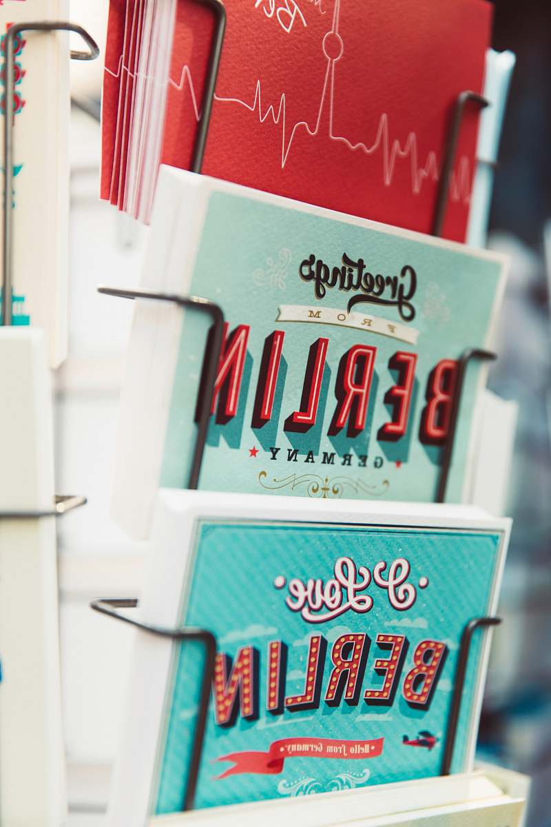 germany shallow focus photography of greeting cards on rack card