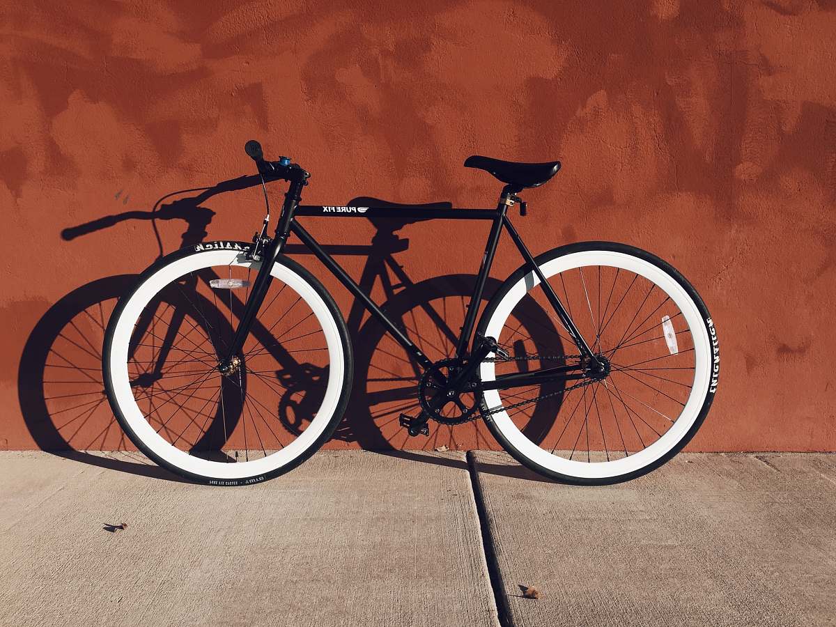 bike black and white mountain bicycle near brown wall red wall