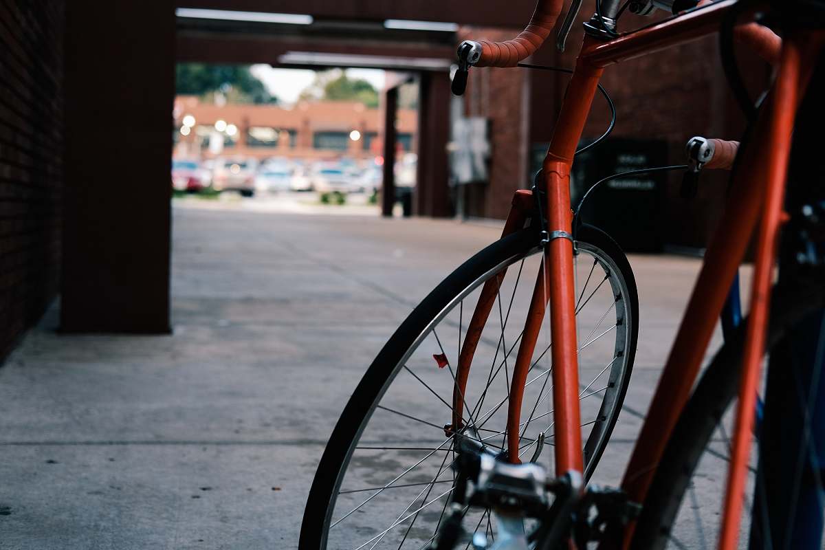 bike red road bike on gray pavement flooring transportation