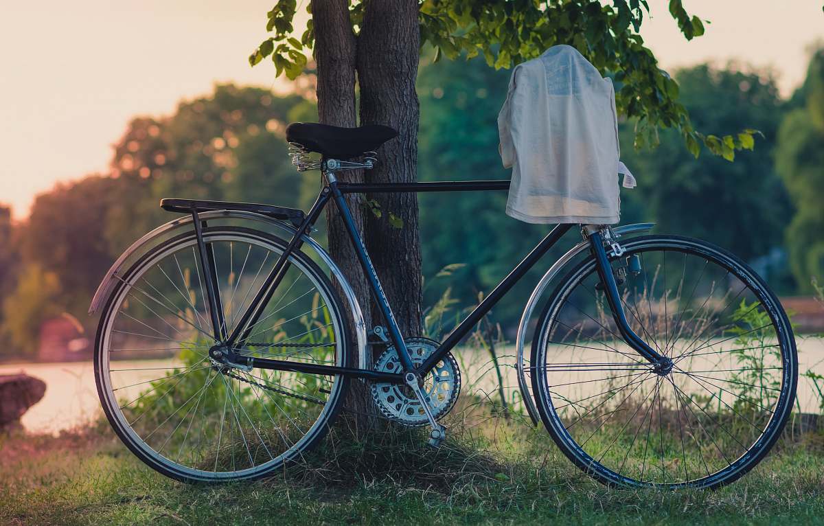 bike white cloth hanged on bike's handlebar leaned on tree bucharest