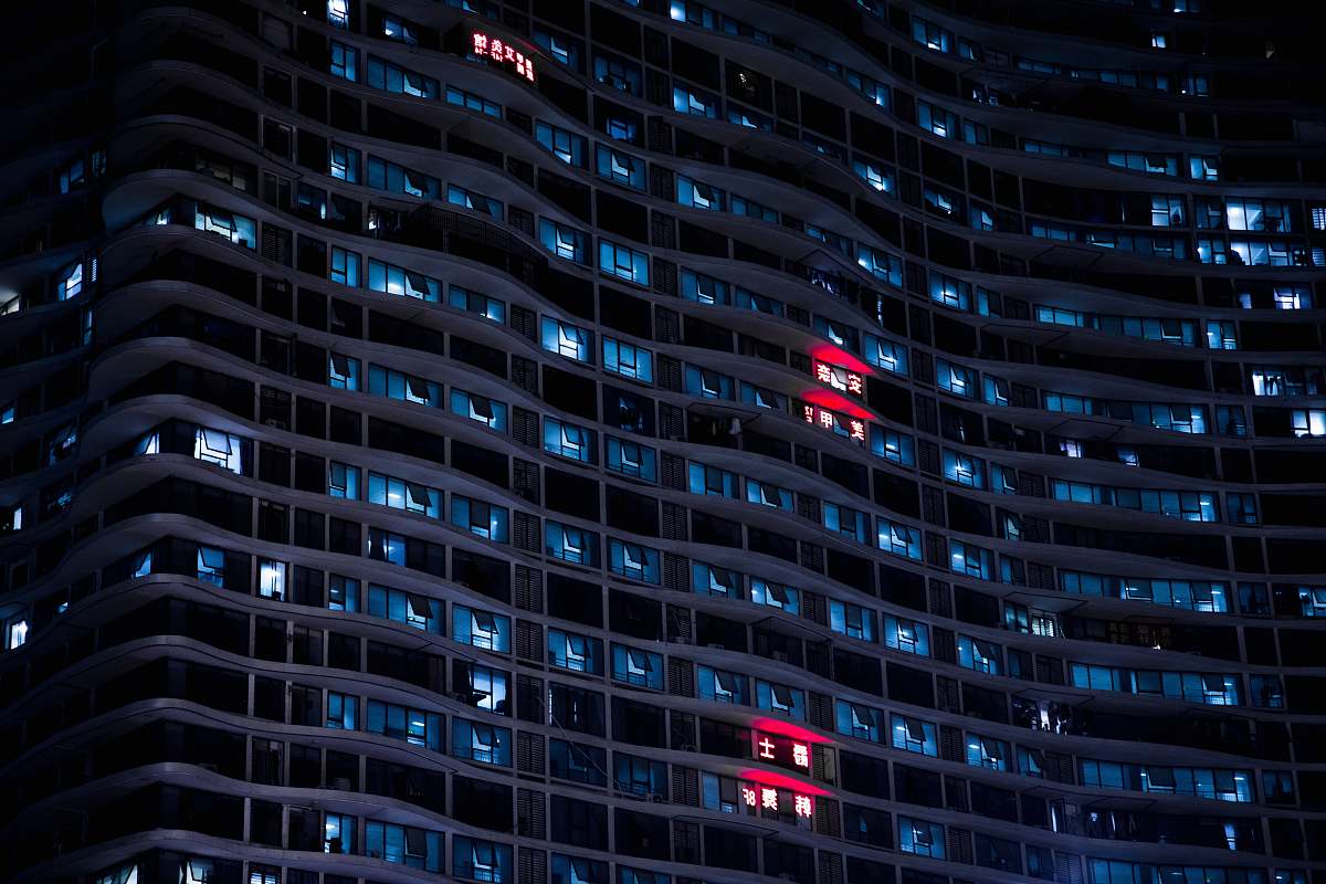 night low-angle photo of high rise building window